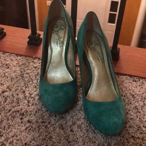 Green suede heels with gold accents